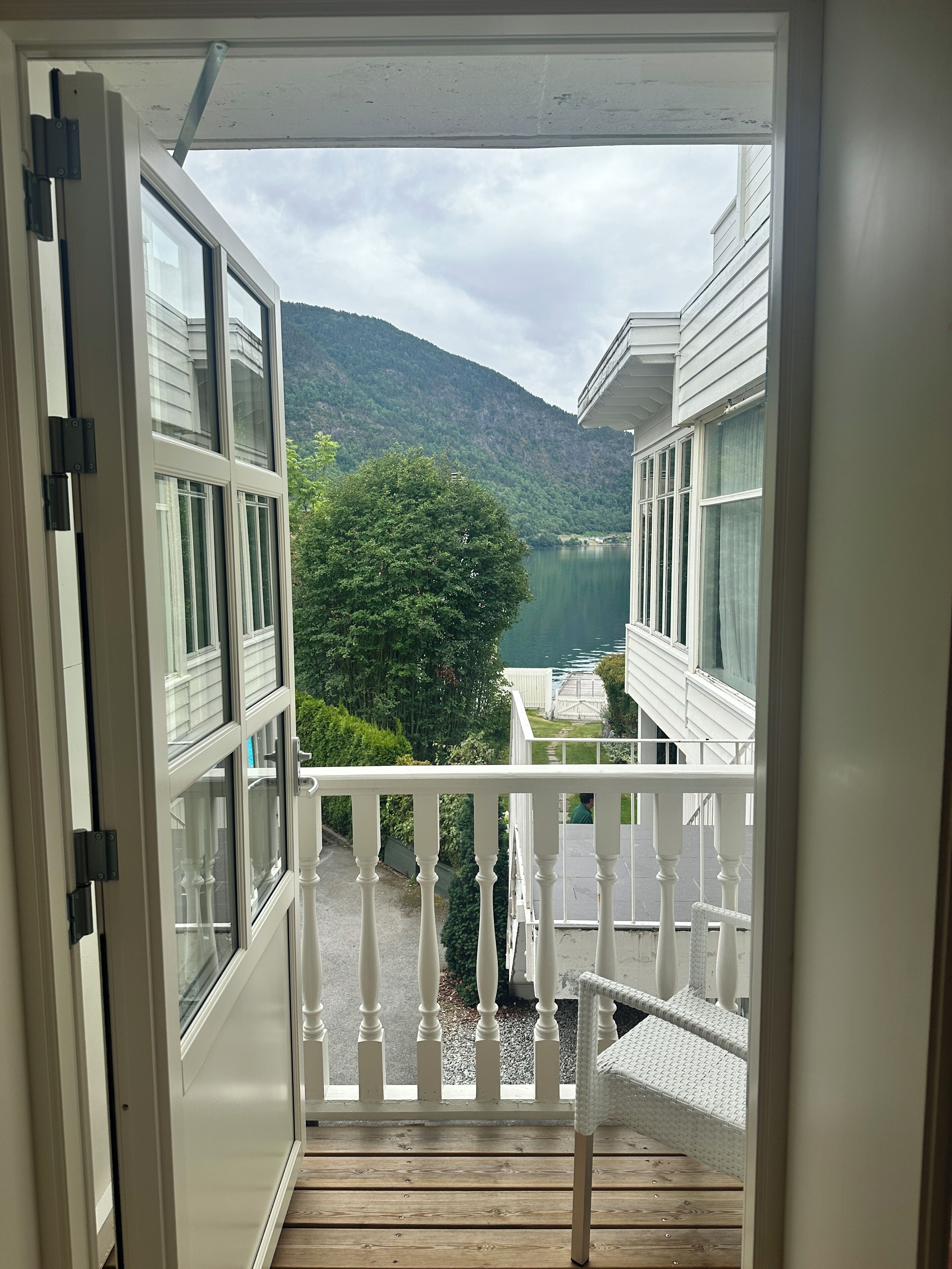 A balcony with a view of a lake and mountains.