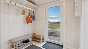 A room with a bench, shoe rack, and a coat rack with bags. - Beautiful home in Tarm with WiFi (Tarm)