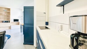 A modern kitchen with a built-in oven, a coffee maker, and a power strip.