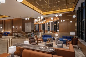 A modern hotel lobby with seating areas, a reception desk, and a chandelier. - Crystal Orange Hotel Yancheng Municipal Government (Yancheng)