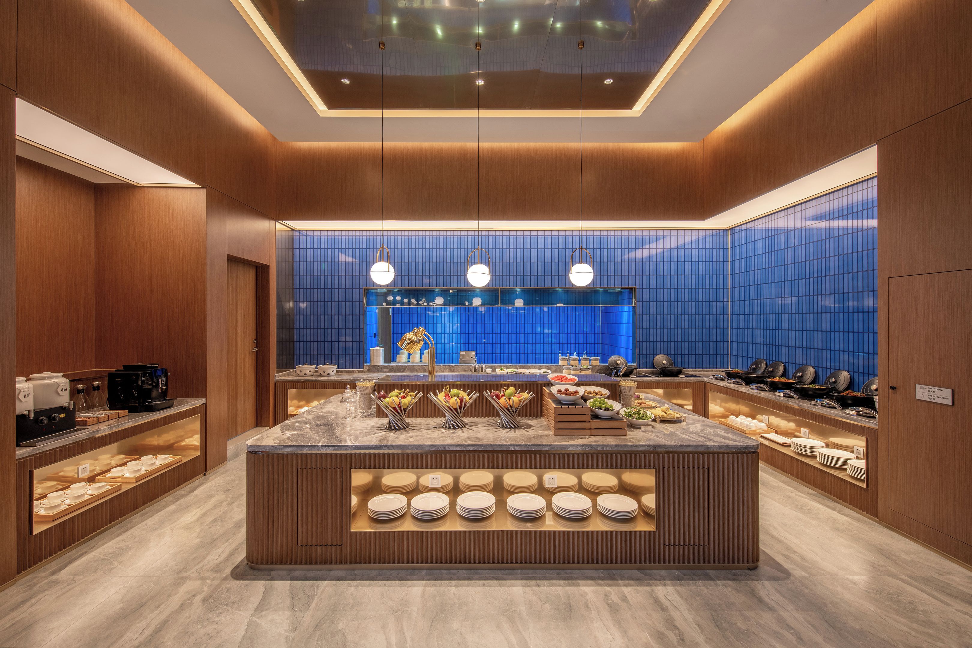 A modern breakfast bar with a central island, wooden paneling, and a blue-tiled backsplash.