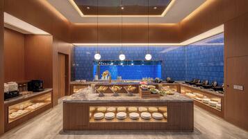 A modern breakfast bar with a central island, wooden paneling, and a blue-tiled backsplash.