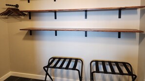 A room with three wooden shelves mounted on a wall, a black metal hanger, and two black metal chairs. - Springdale Farm & Views - the Gorge, Downtown, Mt. Hood (Troutdale)