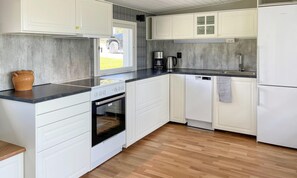 Enjoy cooking in this well-equipped kitchen with an oven, coffee maker, and refrigerator.