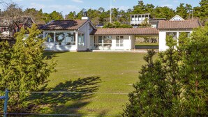 A residential property with a large lawn, a covered patio, and a detached garage. - Amazing home in Rockneby with WiFi (Rockneby)