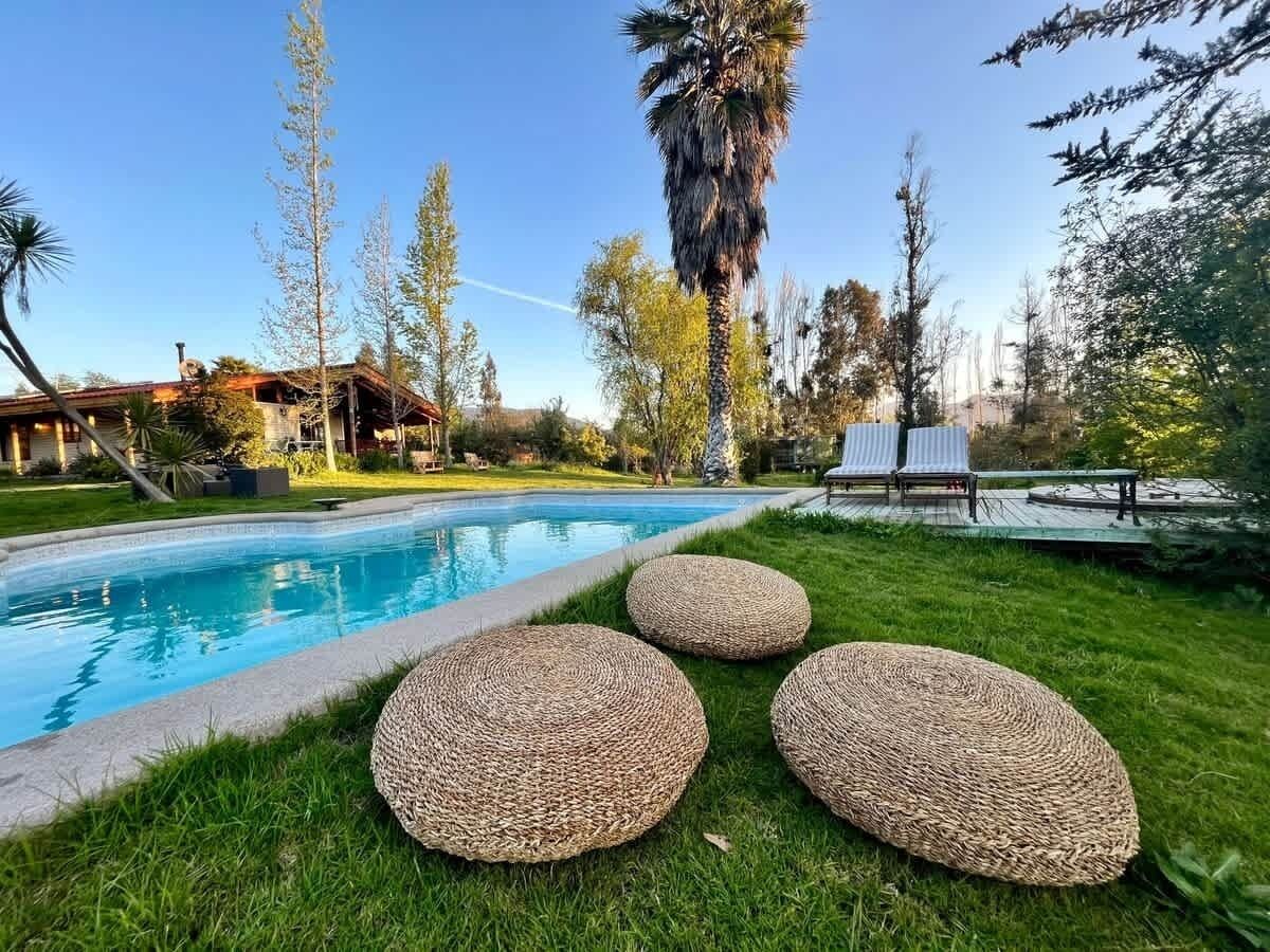 Inviting pool area framed by palms & open green space