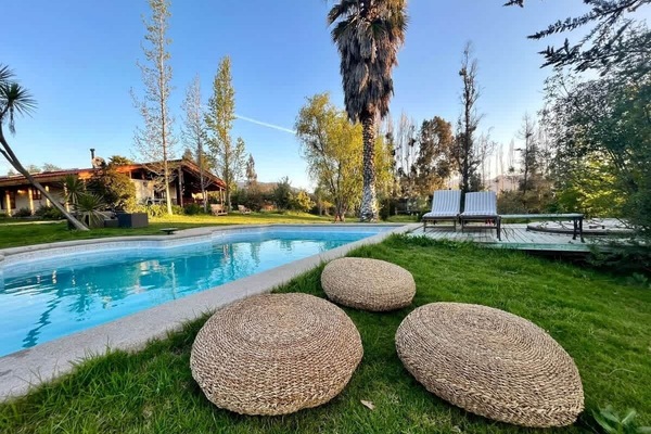 Inviting pool area framed by palms & open green space