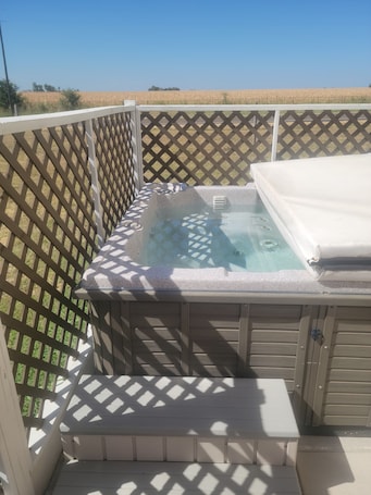 Outdoor spa tub. Kingdom Home Country Cottage is where you can relax, rejuvenate and enjoy peace.