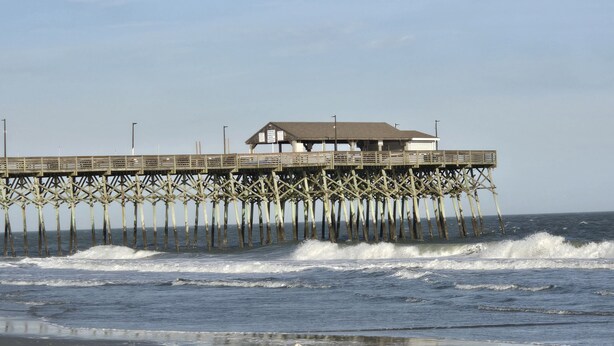 A pier with a building on top, extending into the ocean. - Spacious Beach House, Private Pool, Short Walk to the Beach, Bikes Welcome (Murrells Inlet)