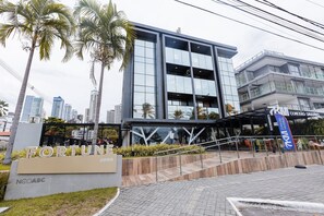 A modern building with a sign reading "FORTUNI 2098" and "NCOABC". - Fortune Cabo Branco (João Pessoa)