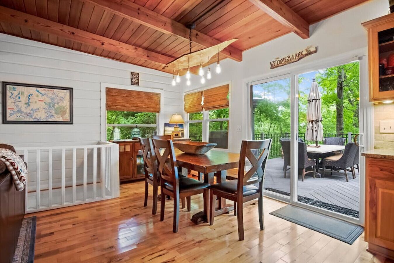 A wooden interior with a dining area, a white radiator, and a view of the outdoors.