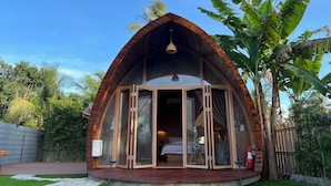A cozy, semi-open wooden structure with a curved roof, large glass doors, and a small porch area. - Found Mansion Langkawi (Langkawi)