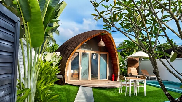 A cozy, semi-open structure with a curved roof, a small deck, and a pool area. - Found Mansion Langkawi (Langkawi)