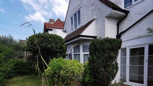 A two-story house with a garden in front. - Ground floor Spacious double bed room, free parking close to seafront. (Bexhill)