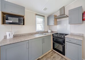 Fridge, oven, stovetop, toaster - 3 bedroom Ribchester Platinum Caravan with balcony at the front. (Longridge, Ribble Valley)