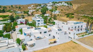 A white building with a flat roof, a balcony, and a sign indicating a hotel. - Apartment In A Hotel 'Pico Bello Patmos 14' with Mountain View, Wi-Fi and Air Conditioning (Patmos)