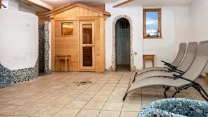 A sauna room with wooden benches, a tiled floor, and a stone wall. - Holiday Apartment "Lindenhof 9" with Shared Garden & Wi-Fi (Vandoies)