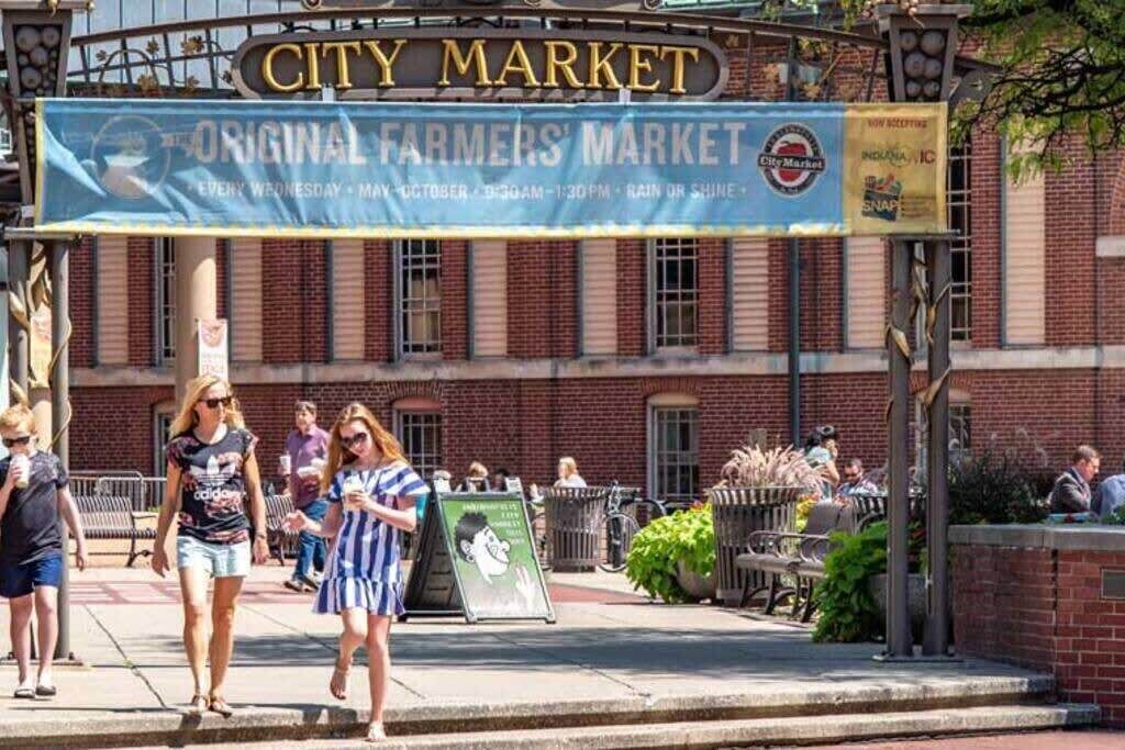 A city market with a sign reading "City Market" and "Original Farmers' Market".