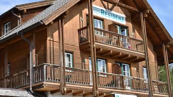 A wooden building with a sign reading "RESIDENZ" and another sign indicating a "RECEPTION".