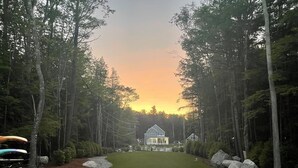 A house surrounded by a forest with a clear path leading to it. - Timeless Memories on Newfound Lake (Hebron)