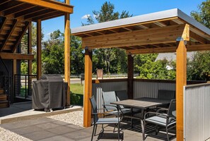 An outdoor patio with a pergola, seating, and a grill. - Winter House - Great home located within walking distance to Main Street! (Bozeman)