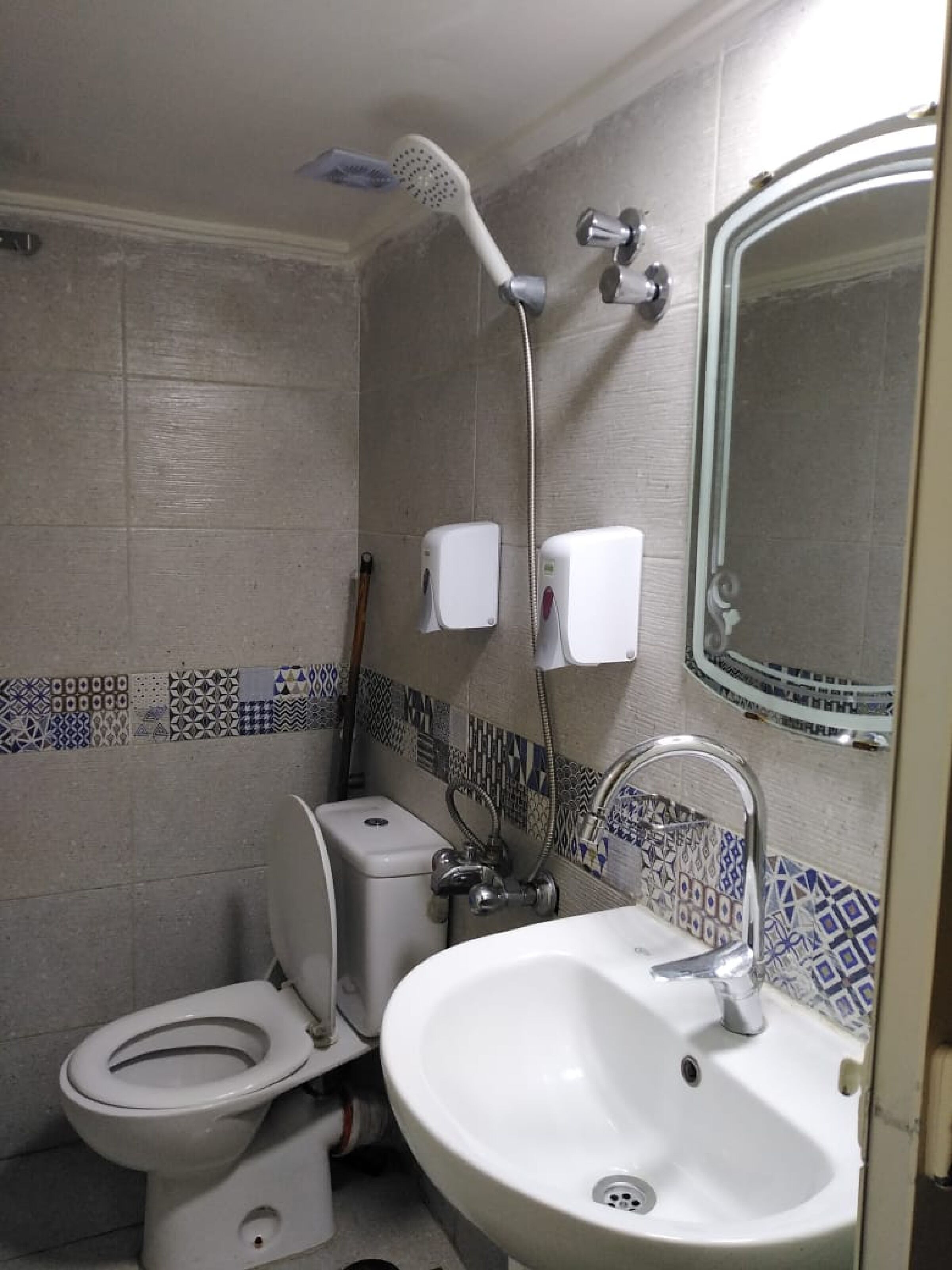 Un baño con inodoro, lavamanos y ducha.
