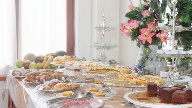 A buffet table with various food items including pastries, meats, and desserts. - Hotel Marittima (Rimini)
