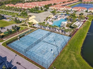 An aerial view of a resort with a large swimming pool, tennis courts, and a marina. - Resort home with south facing pool - 5 bed / 5 bath (Kissimmee)