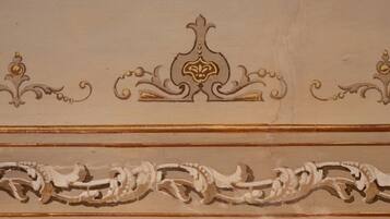 A ceiling with ornate, symmetrical moldings and a central decorative element.