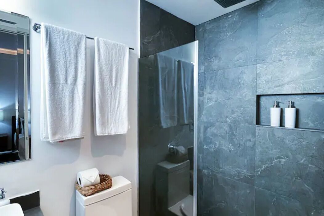 Luxury Apartment | Bathroom | Rainfall showerhead, hair dryer, towels, soap