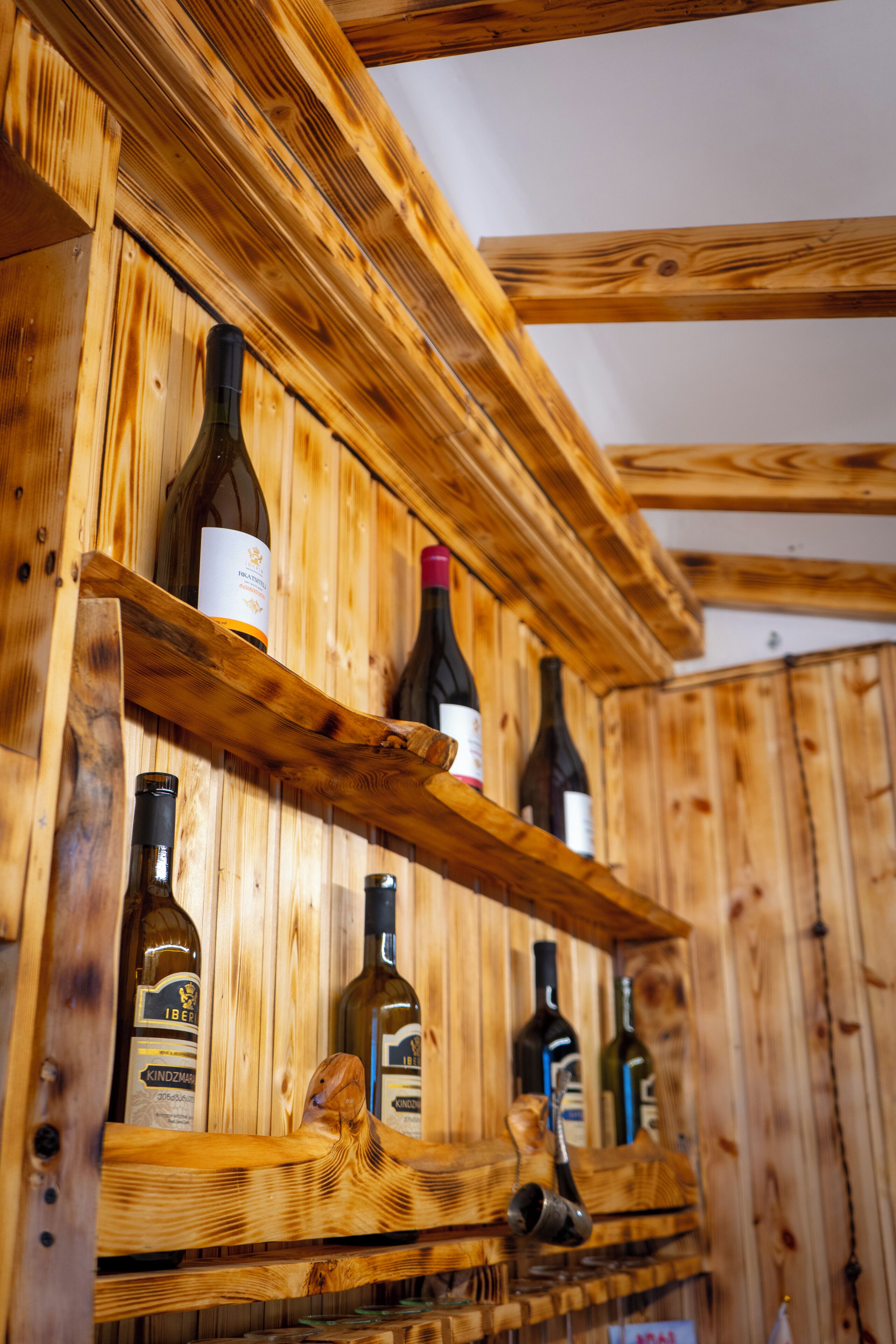 A wooden wine rack with bottles.