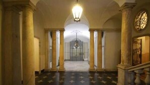 A grand hallway with high ceilings, large columns, and a patterned floor. - Happy Family Apartments Cathedral (Genoa)