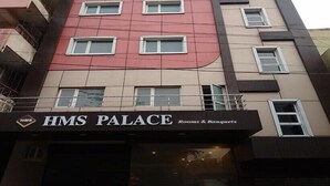 A multi-story building with a sign reading "HMS PALACE Rooms & Banquets". - Hotel HMS Palace (Golmuri)