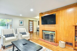 TV, fireplace, books - Modern Home w/ Spacious Yard in Beaverton! (Beaverton)
