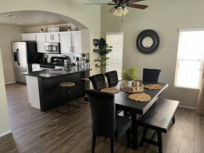 Enjoy meals in the kitchen and dining area with oven, microwave, and stainless steel refrigerator.