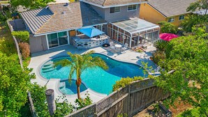A residential property with a swimming pool, a covered patio, and a fenced backyard. - Charming Country-Style Home with Backyard Oasis! (Laguna Hills)