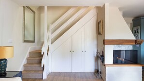 A staircase leading to a loft bedroom with a fireplace. - Nest Lodge, a stunning three bedroom lodge surrounded by nature (Pulborough)