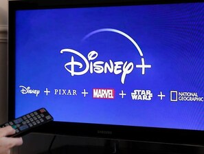 A television screen displaying the Disney+ logo with additional service logos.