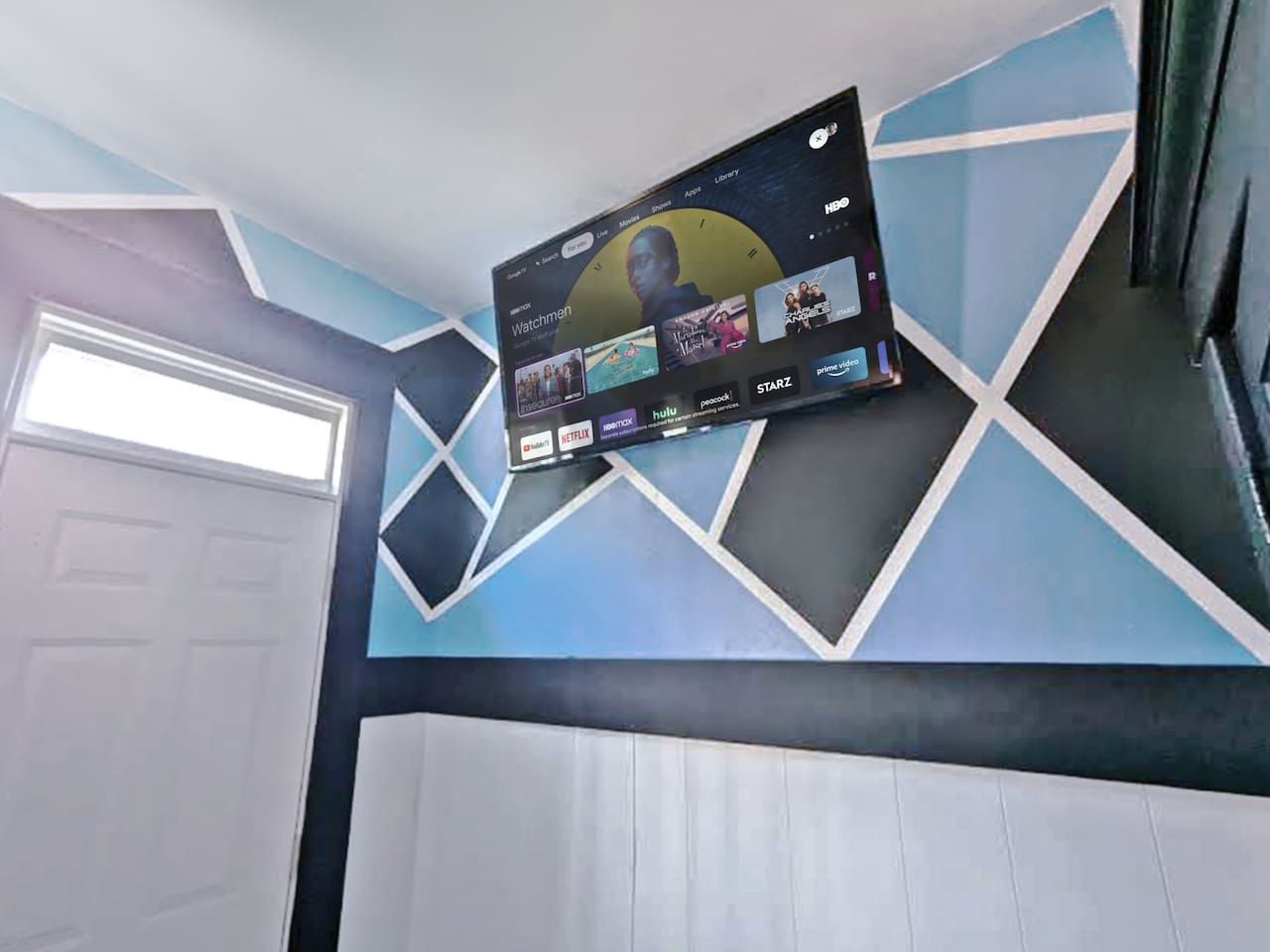A wall-mounted television displaying various streaming services.