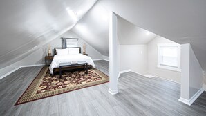 A bedroom with a bed, a rug, and a window. - Spacious 4BD 2BA Home Near OSU (Columbus)