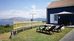 A house with a patio overlooking a body of water and mountains. - Restored fisherhouse for 6 persons (Lira (Santa Maria))