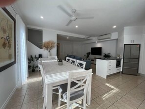 Dining room with seating for 8 adjacent to modern kitchen