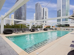 Relax by the rooftop pool with a view of the surrounding high-rise buildings.
