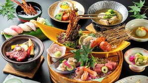 A variety of dishes including seafood, sashimi, and a hot pot, arranged on a table. - Kokumin Shukusya Marin Terrace Ashiya (Ashiya)