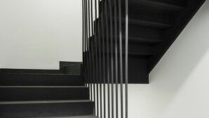 A modern staircase with black steps and vertical black railings. - Persona Hotel Galata (Istanbul)