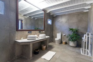 A modern bathroom with a large mirror, two sinks, a toilet, and a shower. - We Escape (Weligama)