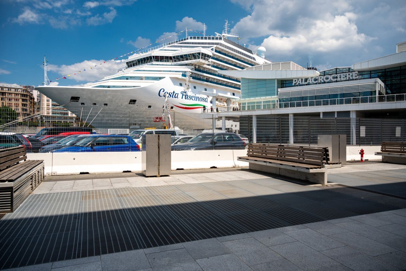 A cruise ship docked at a port with a building labeled 'Palacrocieri' in the background.