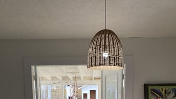 Enjoy meals with family and friends in this cozy dining area, featuring a round table for four and comfortable seating.