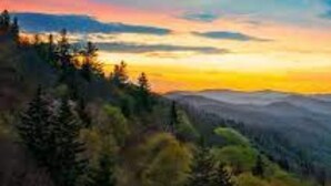 A mountainous landscape with a sunset.