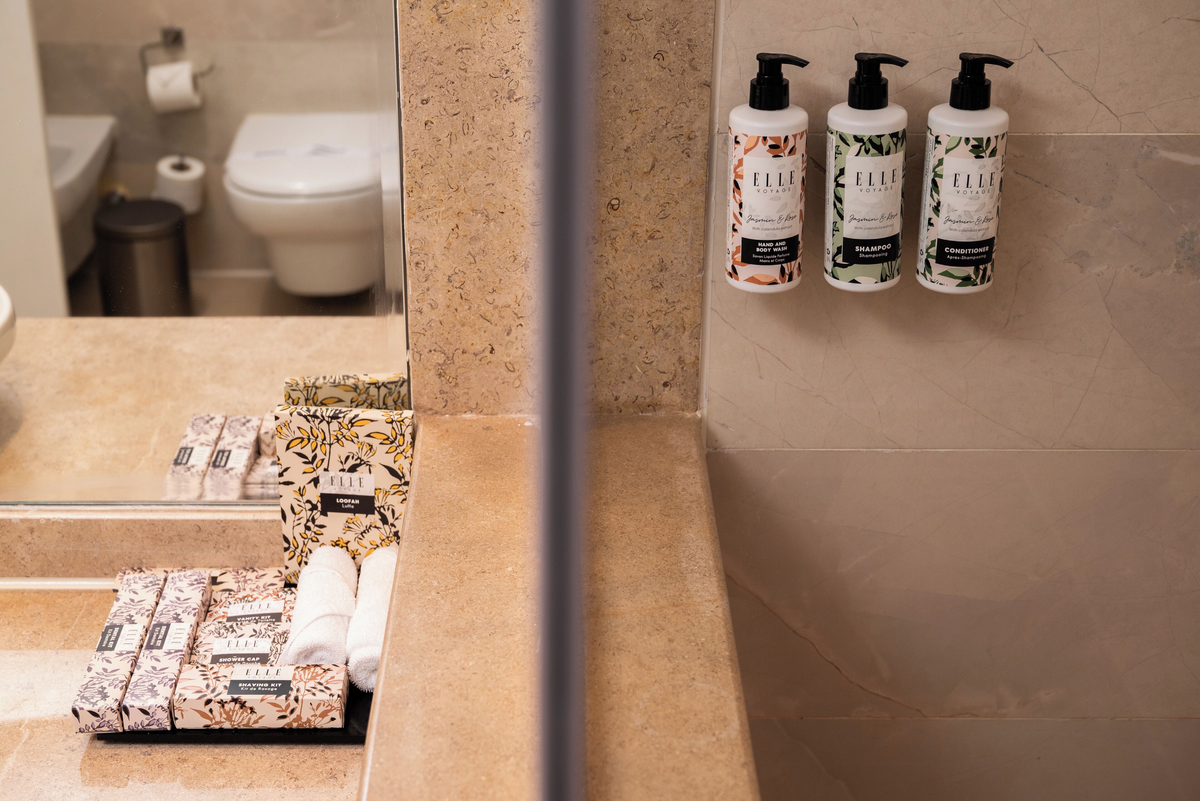 A bathroom with toiletries and a mirror.